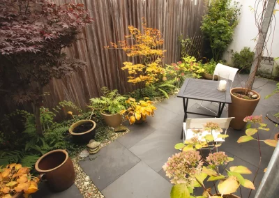 Kleiner Stadtgarten mit Beeten und Steinplatten